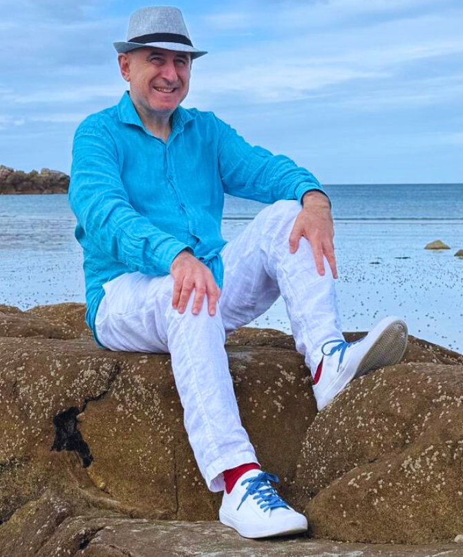 David Green sitting calmly on Pembroke Bay beach in Guernsey
